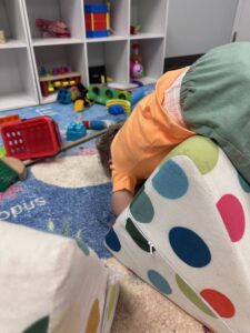 Safe toddler climbing play on foam cushions at daycare in Pewaukee