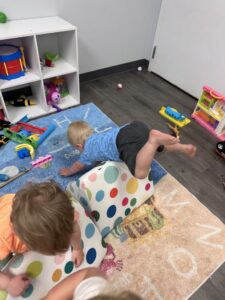Toddler climbing play in the Sprouts room at Just Like GRAMMY and POPPOP's